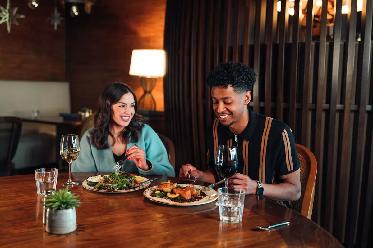 a man and woman eating at a table